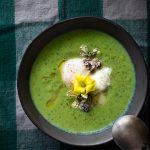 bowl of green soup with an egg